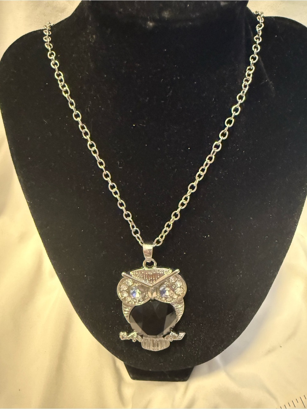 silver-tone owl pendant necklace with large black gemstone centerpiece